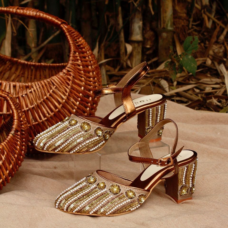 Chair,Wicker,Footwear,Fashion accessory,Metal,Shoe,Table,Furniture,Jewellery,Sandal