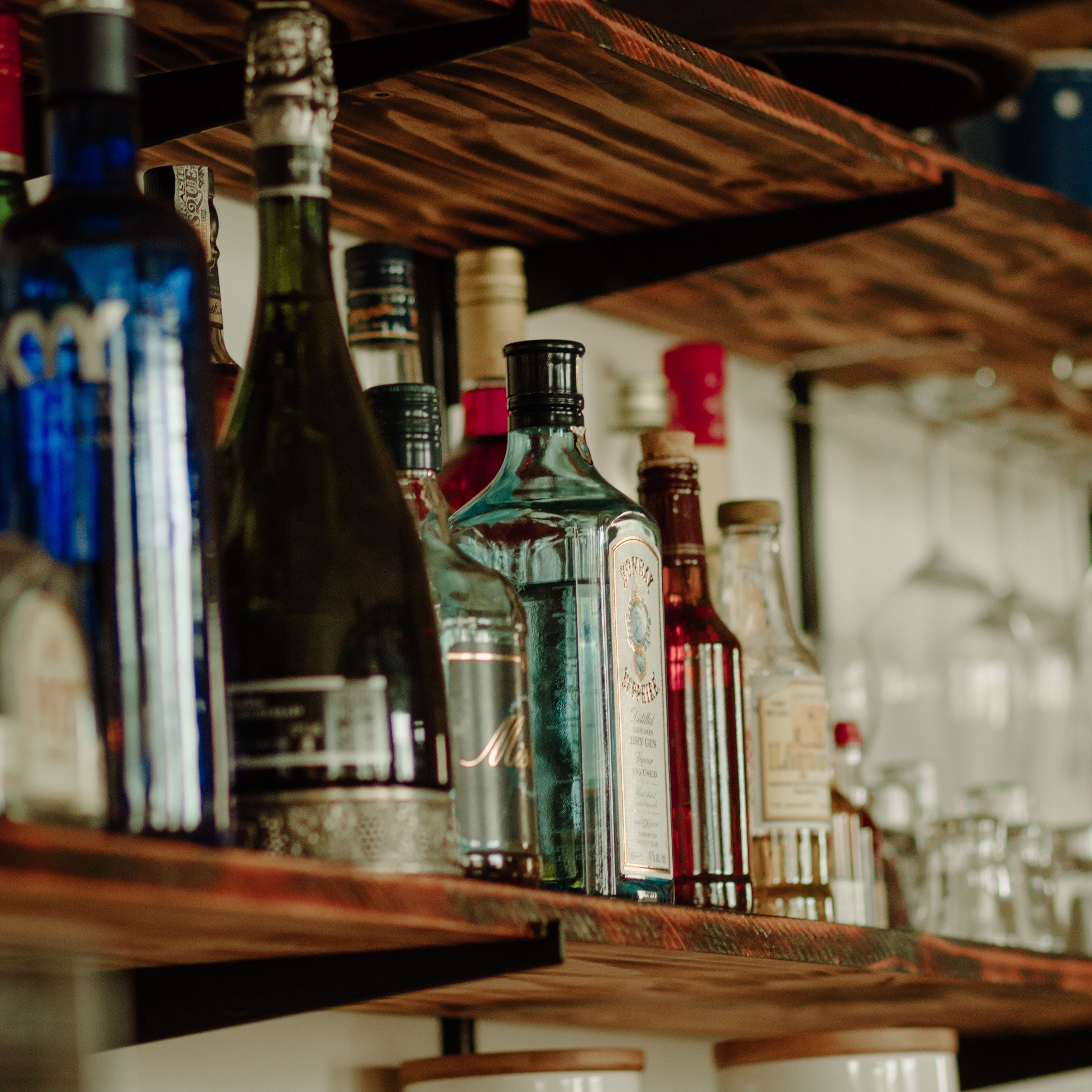 Glass bottle,Bottle,Alcohol,Drink,Liqueur,Distilled beverage,Barware,Glass,Furniture,Wood