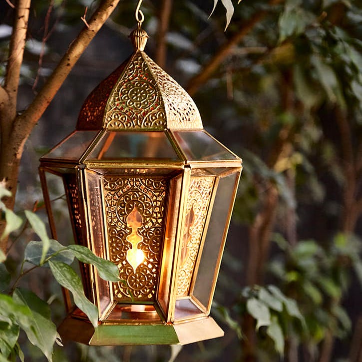 Lighting,Lantern,Light fixture,Tree,Lamp,Bird feeder,House,Plant,Italian food,Interior design