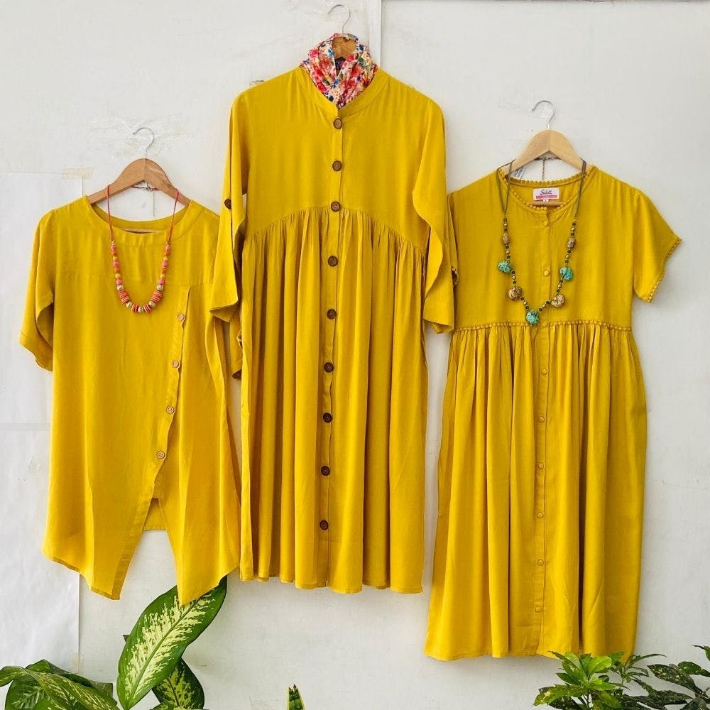 Clothing,Yellow,Clothes hanger,Sleeve,Collar,Outerwear,Dress,Blouse,Button,Fashion design