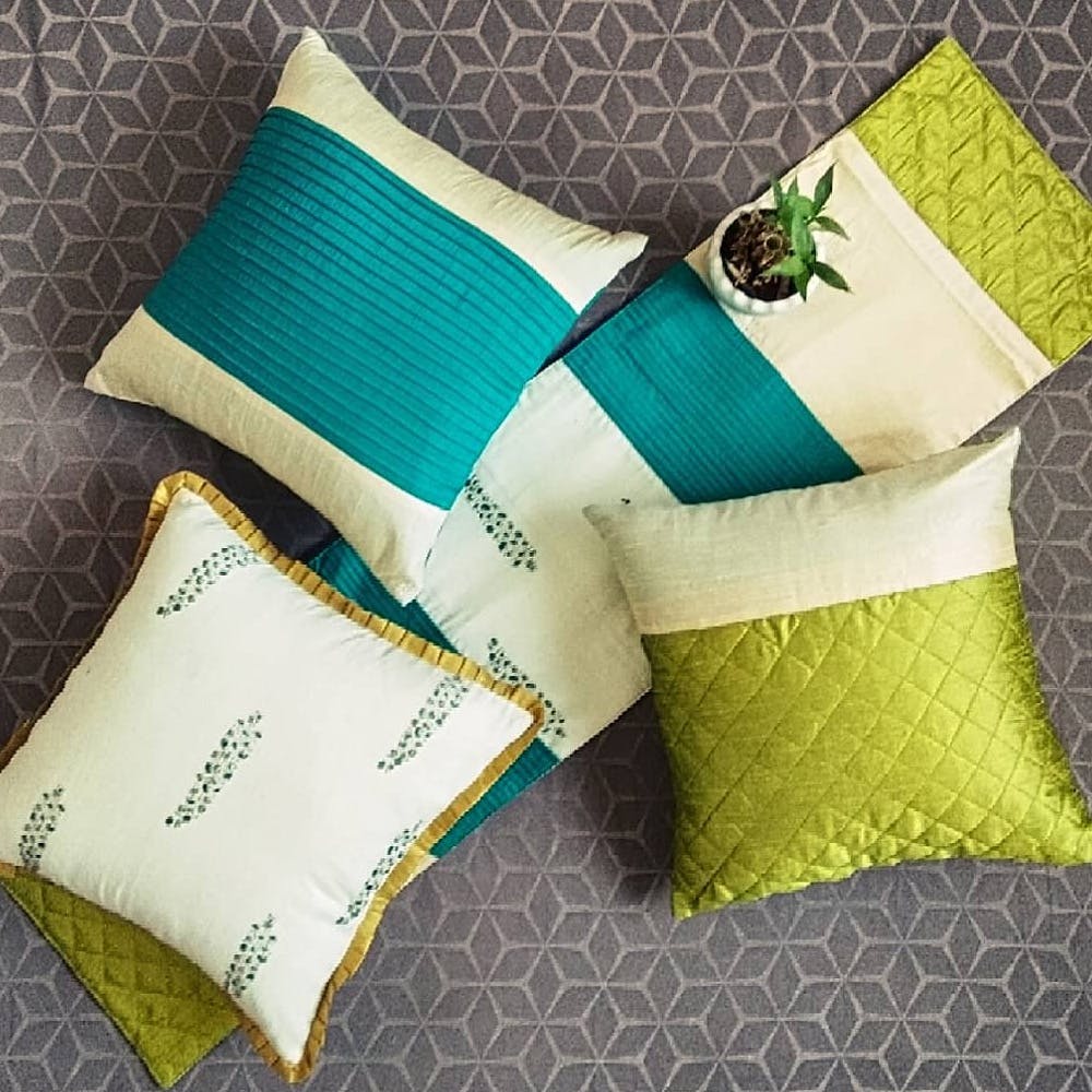 Green,Cushion,Pillow,Yellow,Throw pillow,Turquoise,Font,Textile,Linens,Furniture
