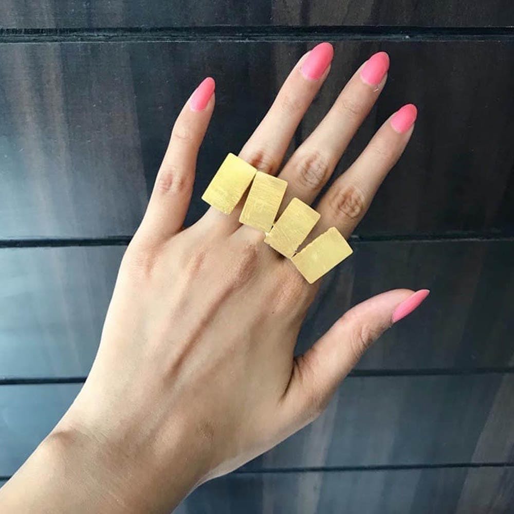 Finger,Nail,Hand,Yellow,Thumb,Gesture,Material property,Ring,Wrist,Fashion accessory