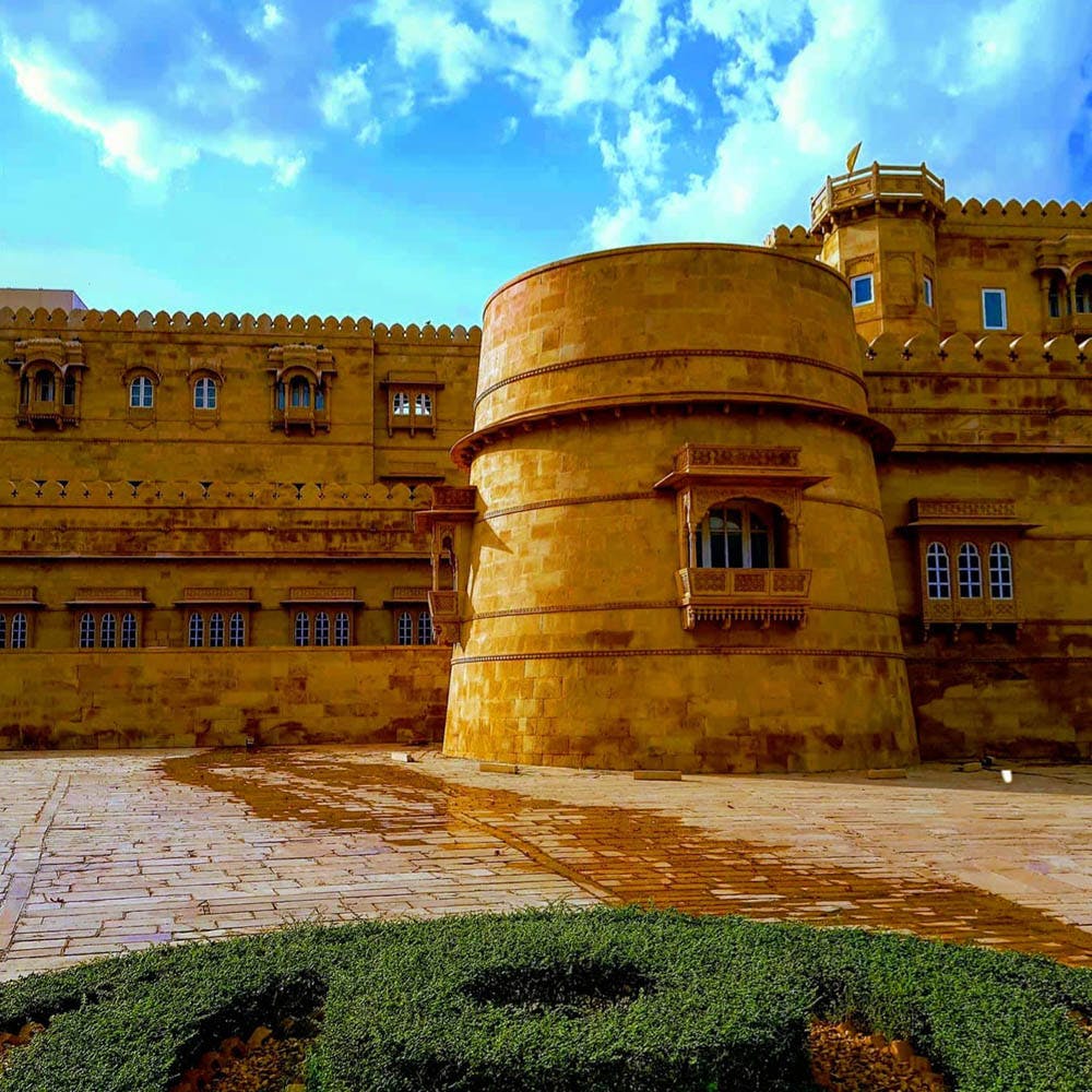 Sky,Landmark,Building,Yellow,Architecture,Historic site,Wall,Palace,Cloud,Estate