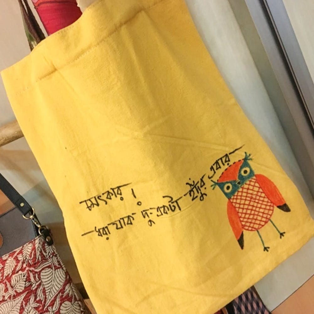 Yellow,Font,Textile,Tote bag,Paper bag,Fashion accessory,Pattern,Paper