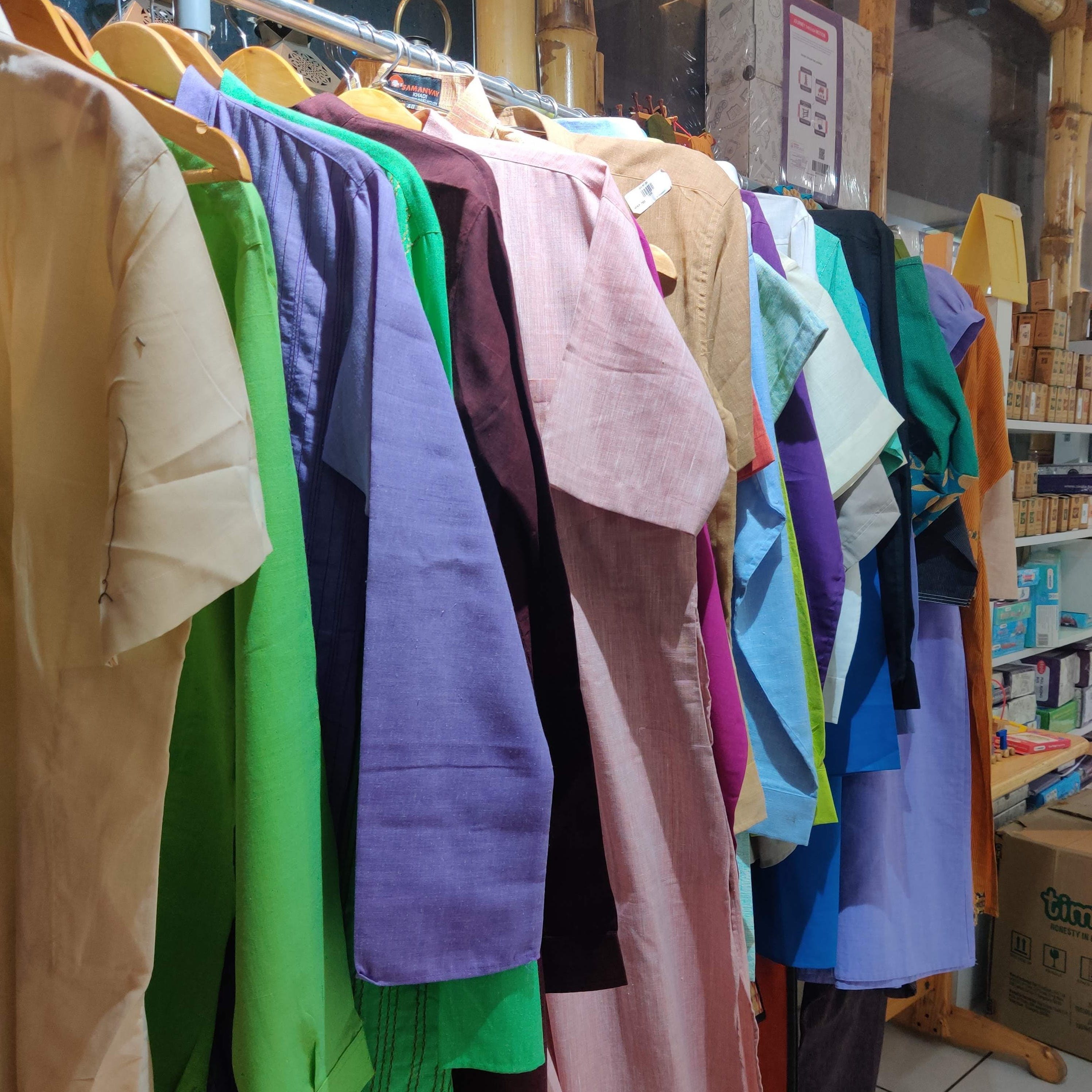 Textile,Purple,Clothes hanger,Shelf,Bookcase,Box,Human settlement,Shipping box,Shelving,Market
