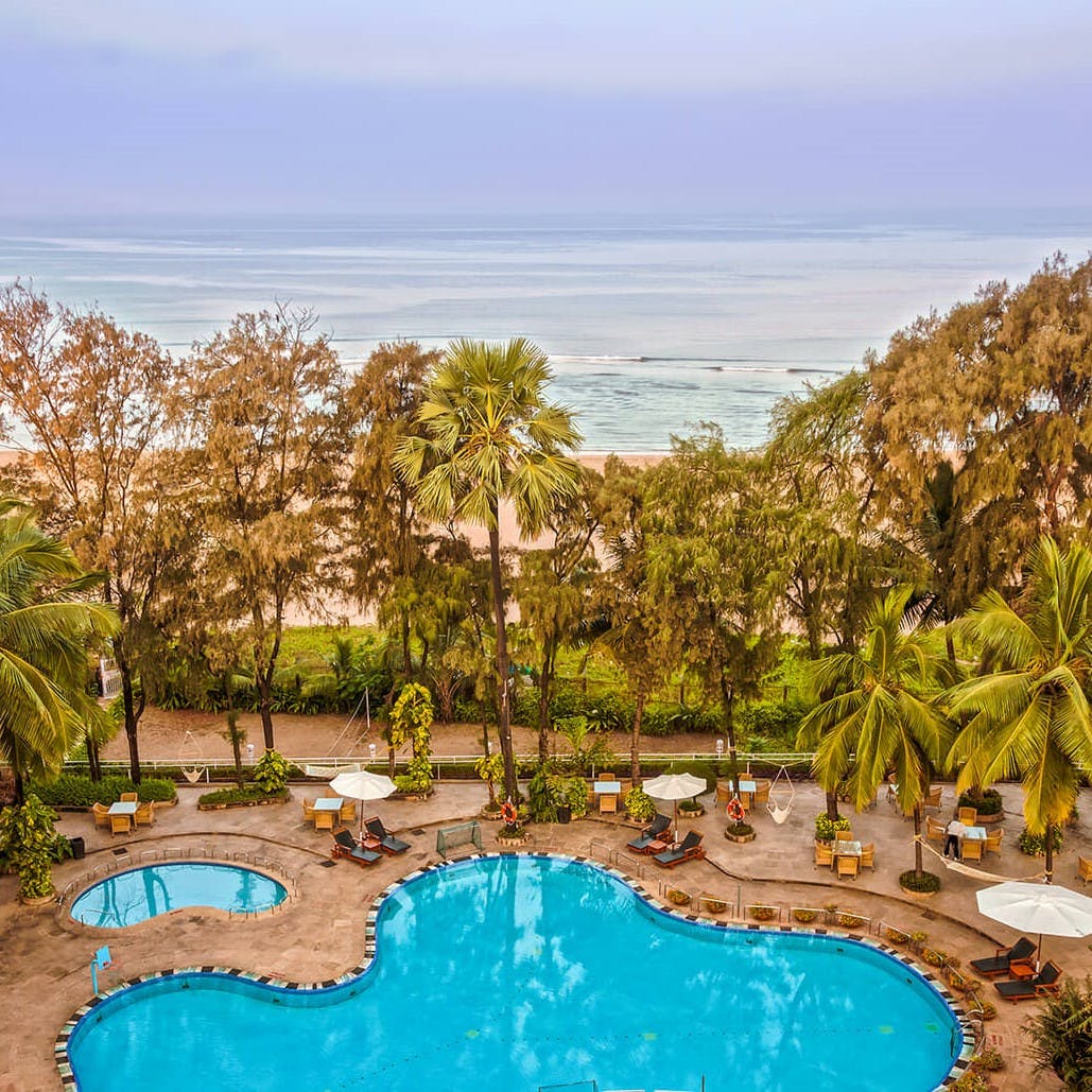 Swimming pool,Water,Resort,Azure,Arecales,Aqua,Tropics,Resort town,Palm tree,Seaside resort