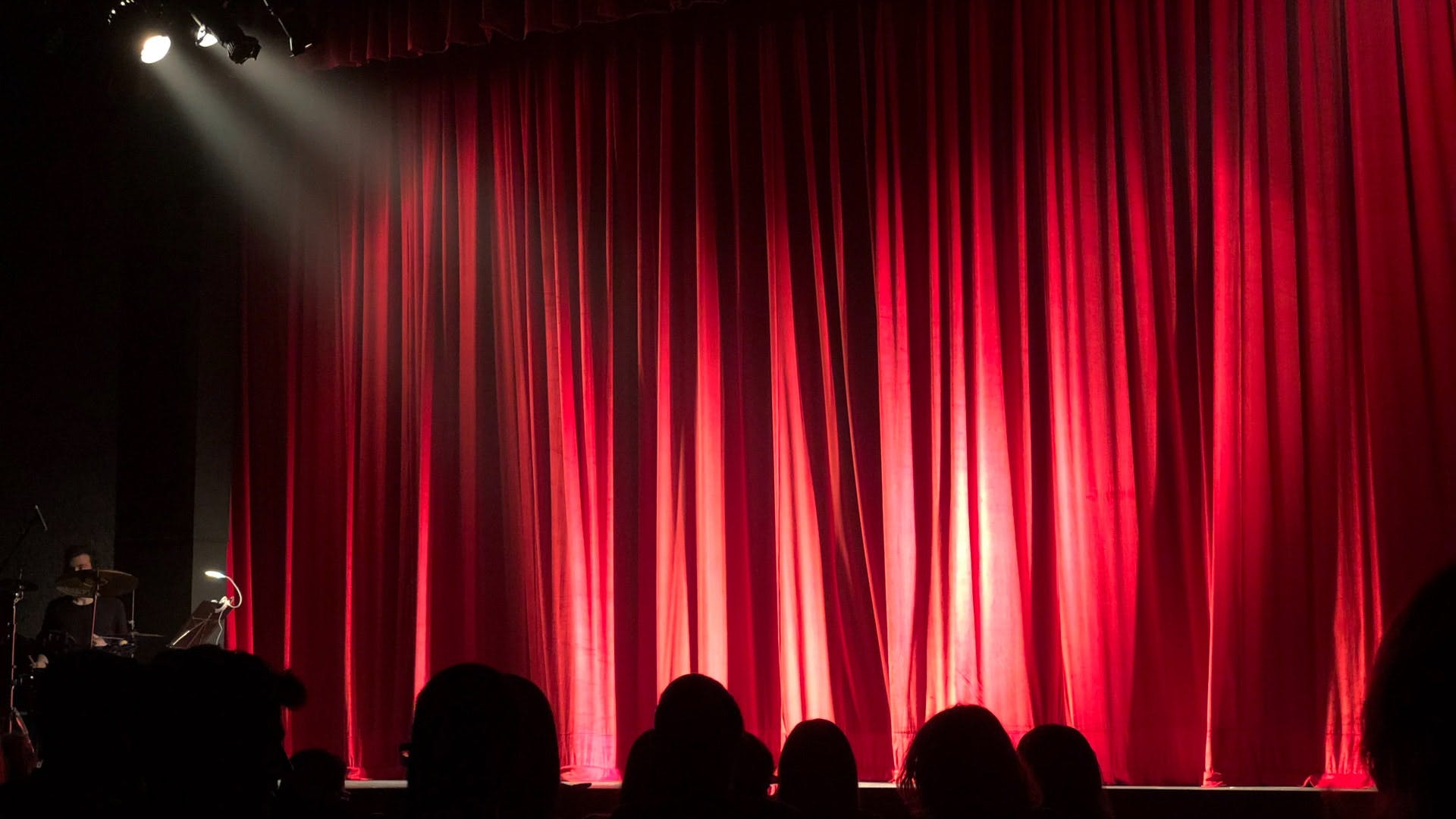 Textile,Red,Interior design,Stage,Theater curtain,Theatre,Magenta,Interior design,Performing arts center,Stage is empty