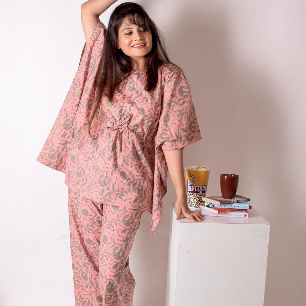 Sleeve,Long hair,Serveware,Peach,Coffee cup,Cup,Nurse uniform,Gesture,Medical,Nightwear