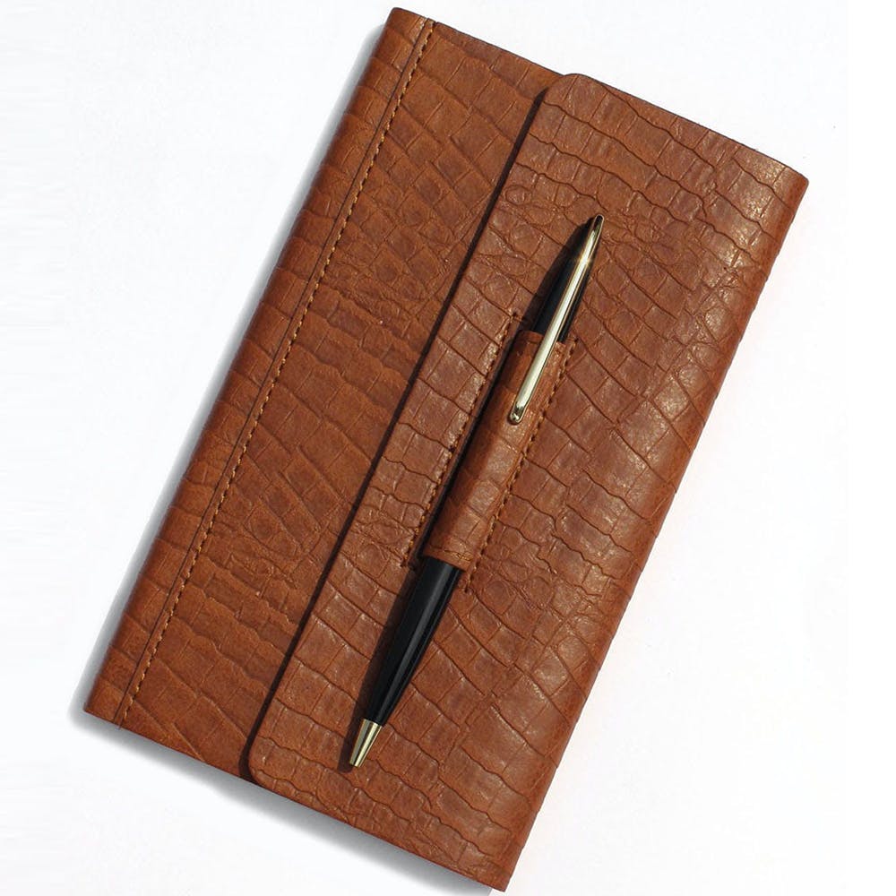 Brown,Rectangle,Wood,Font,Metal,Fashion accessory,Office supplies,Brand,Leather,Paper product