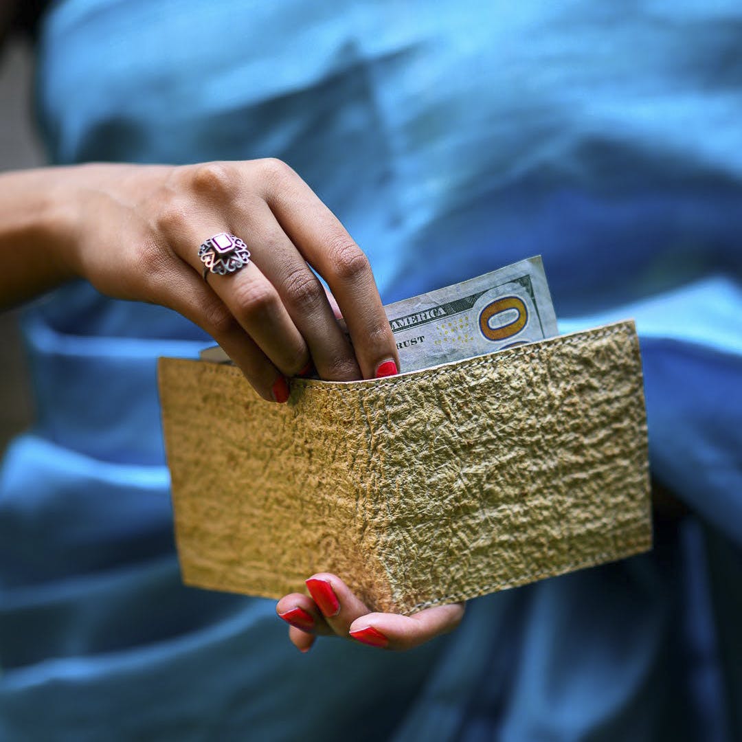 Hand,Sleeve,Gesture,Finger,Font,Book,Street fashion,Electric blue,Wood,Bag