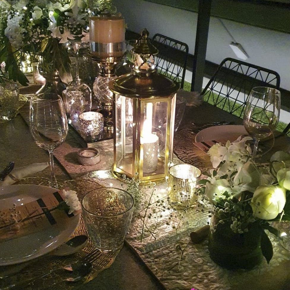Tableware,Table,Drinkware,Stemware,Decoration,Plant,Candle,Lighting,Interior design,Wine glass