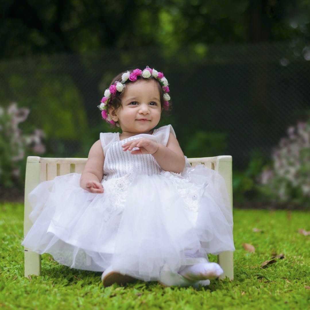 Clothing,Plant,Dress,Smile,Petal,Flash photography,Happy,Baby & toddler clothing,People in nature,Pink