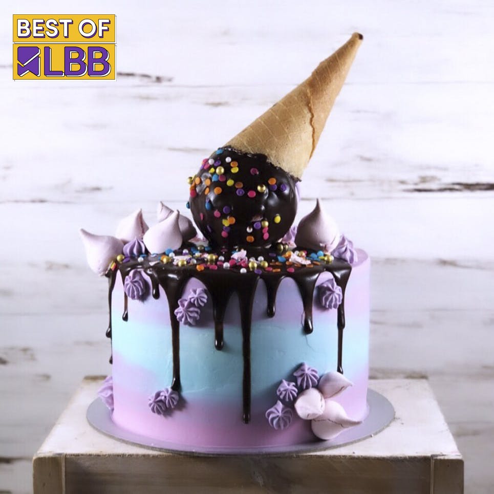 Food,Cake decorating,Cake decorating supply,Purple,Cake,Cone,Headgear,Pink,Baked goods,Hat