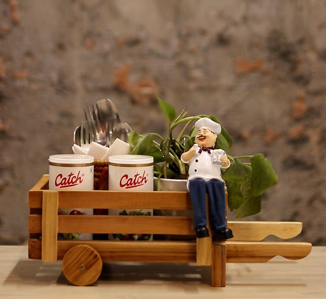 Wood,Table,Toy,Plant,Grass,Outdoor furniture,Wheel,Landscape,Hat,Hardwood