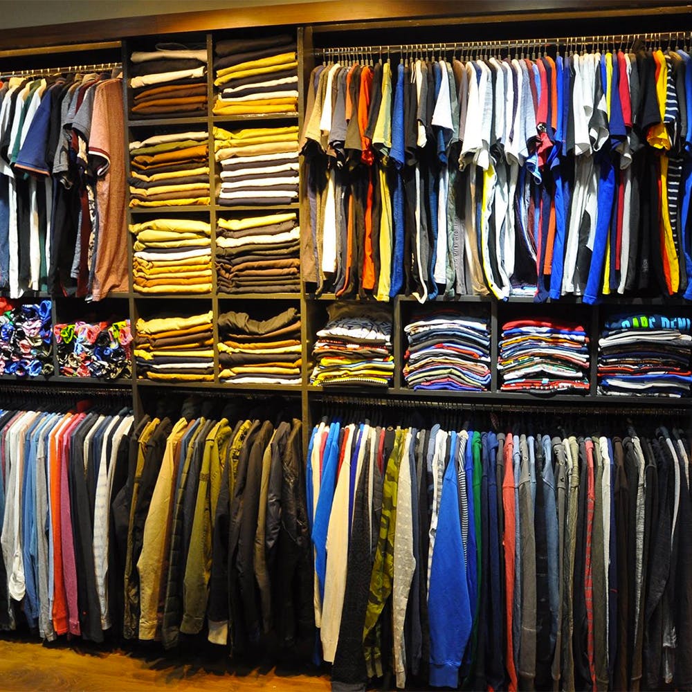 Outerwear,Furniture,Shelf,Shelving,Building,Clothes hanger,Closet,T-shirt,Hat,Fashion accessory