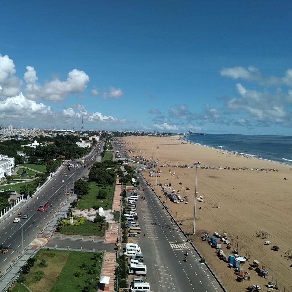 Cloud,Sky,Water,Car,Beach,Building,Thoroughfare,Urban design,Landscape,Road