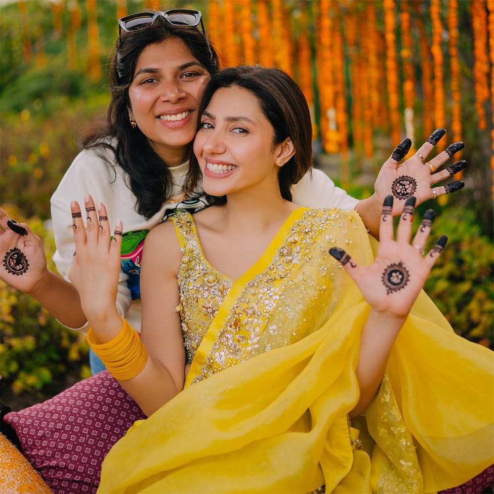 Photo of Alanna & Ivor in pastel outfits on their haldi ceremony