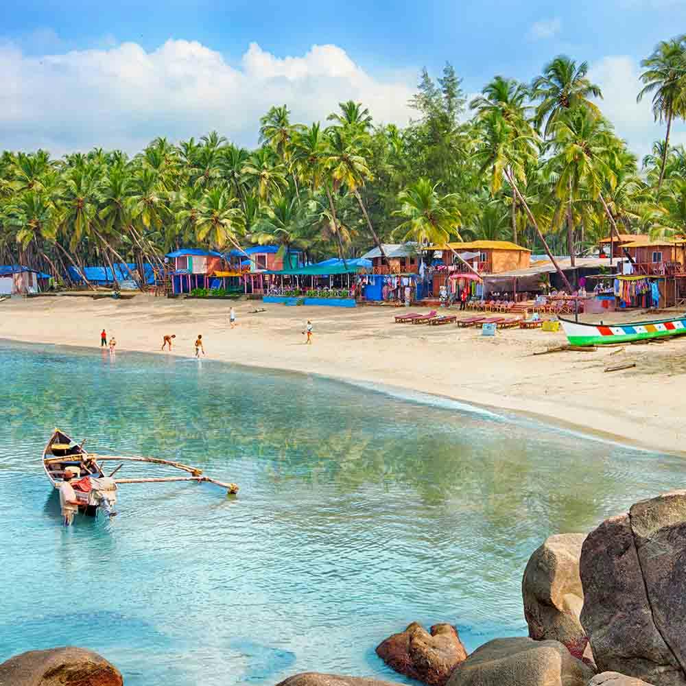 Water,Sky,Cloud,People on beach,Azure,Blue,Tree,Beach,Travel,Coastal and oceanic landforms