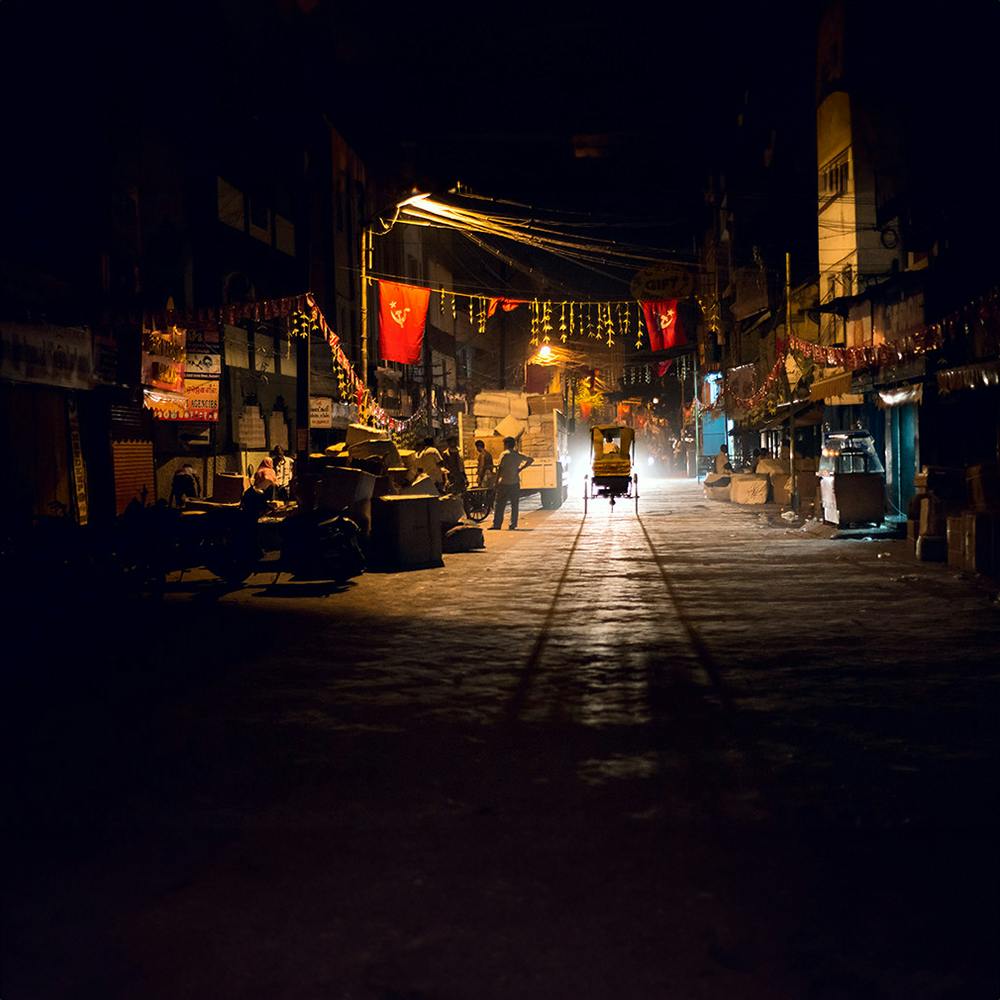 Building,Road surface,Automotive lighting,Sky,Electricity,Asphalt,Tints and shades,City,Road,Darkness