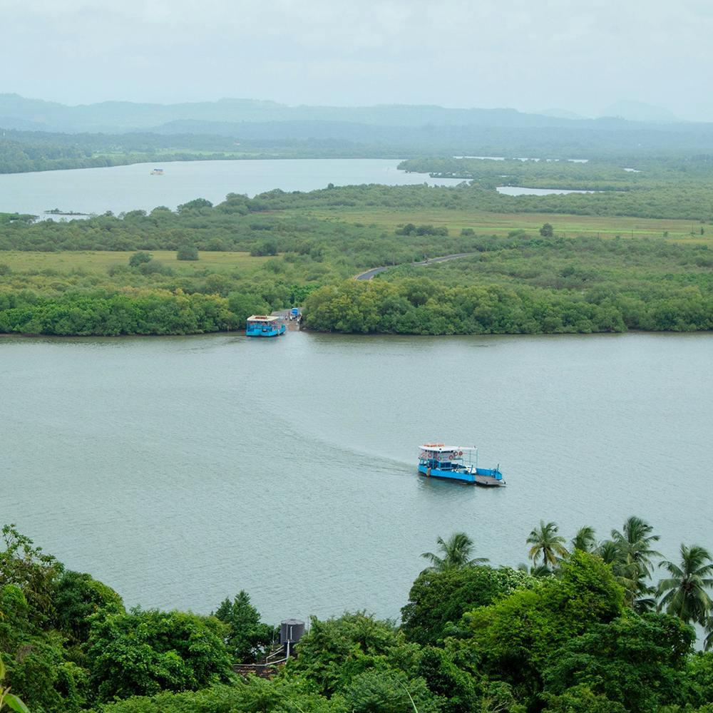 Water,Boat,Water resources,Sky,Green,Plant,Natural landscape,Vegetation,Lake,Highland