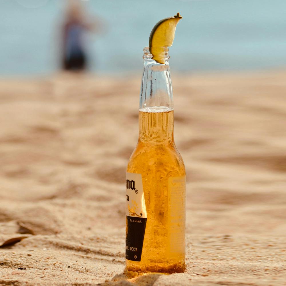 Bottle,Liquid,Drinkware,Orange drink,Glass bottle,Fluid,Beer,Beer bottle,Amber,Solution