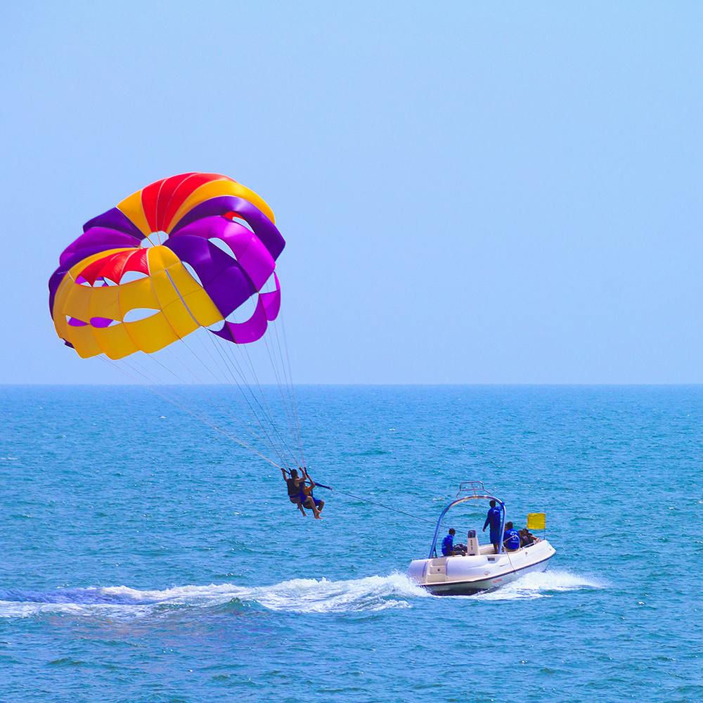 Water,Sky,Vertebrate,Parachute,Boat,Travel,Leisure,Windsports,Sports,Recreation