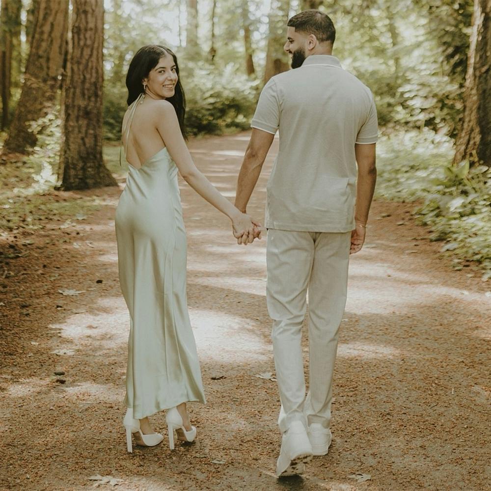 Plant,People in nature,Smile,Flash photography,Tree,Happy,Gesture,Grass,Holding hands,Gown