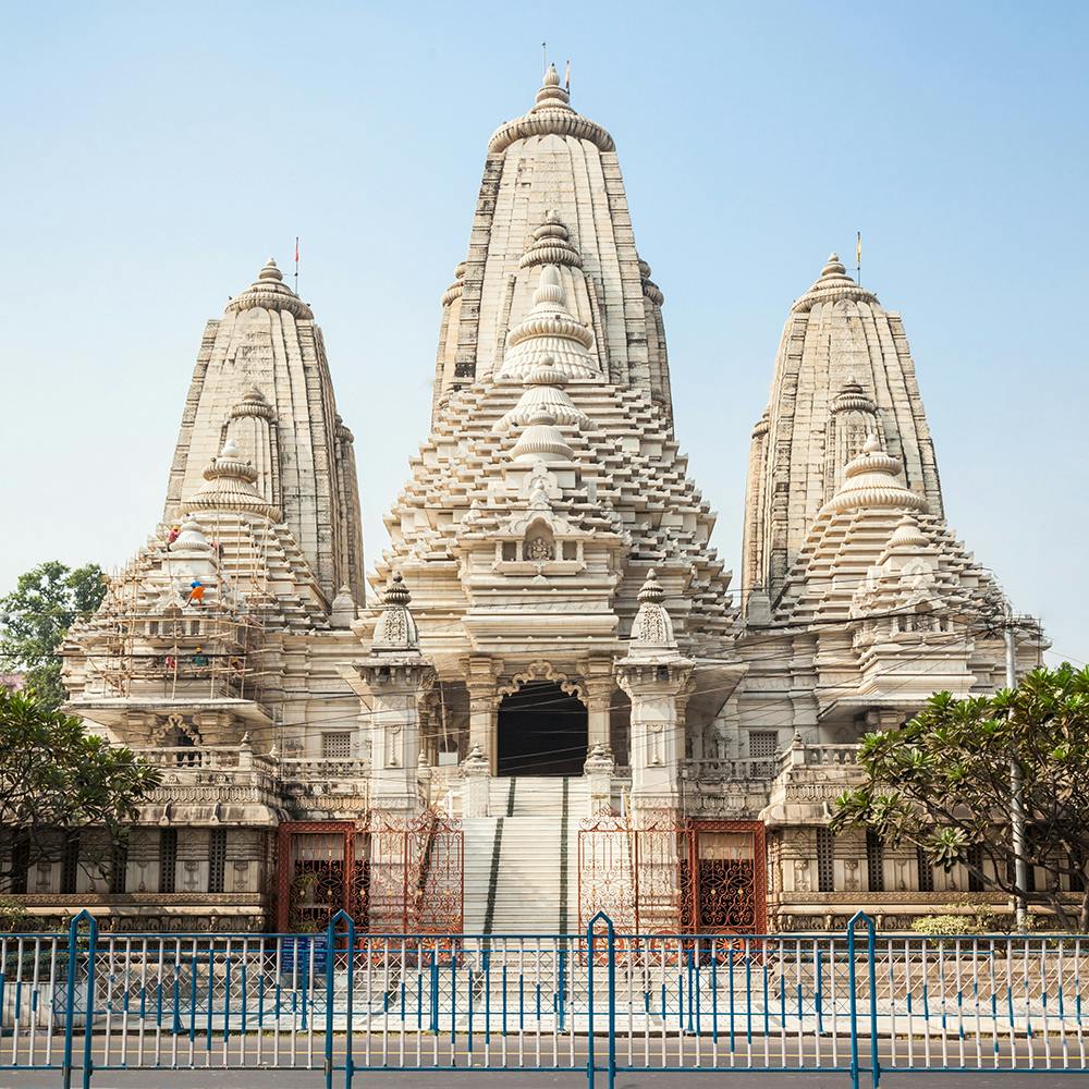 Sky,Fence,Facade,Temple,Tree,Sculpture,Art,Symmetry,Medieval architecture,Hindu temple